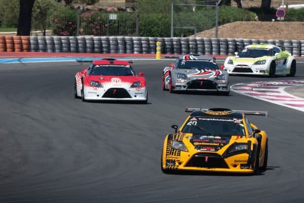 Groupe de voitures de course sur circuit illustrant les catégories du sport auto